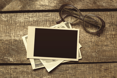 old photos on the wooden tableの写真素材