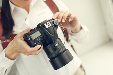 Pretty woman is a professional photographer with dslr cameraの写真素材