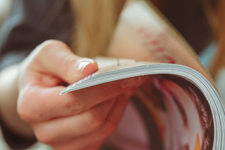 woman reading magazine at homeの写真素材