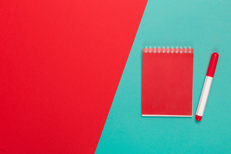 Blank paper notepad on bright bicolor background for your design, top viewの写真素材