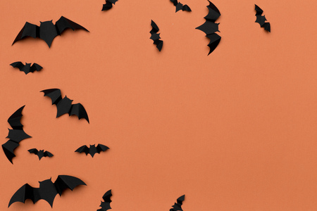 halloween and decoration concept - paper bats flying