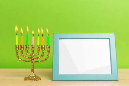 Bronze Hanukkah menorah with burning candlesの写真素材