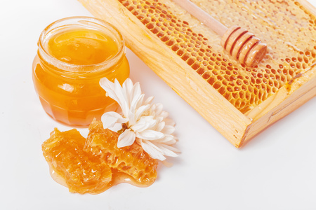 jar of honey and stick isolated on white backgroundの写真素材