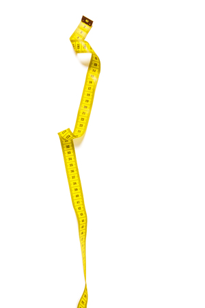 yellow metric measuring tape isolated on white panorama backgroundの写真素材