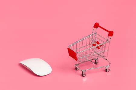 Shopping cart or supermarket trolley on pink backgroundの写真素材