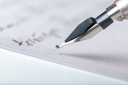 Fountain pen on an antique handwritten letterの写真素材