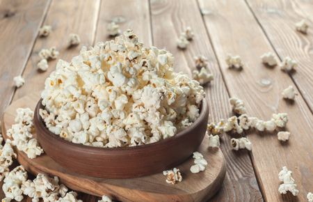 Salt popcorn on the wooden tableの写真素材