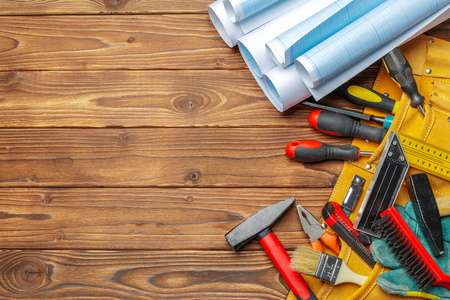 Assorted work tools on wooden table