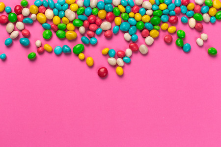 Colorful lollipops on a pink background