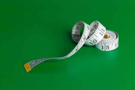 measure tape on a green backgroundの写真素材