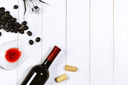 wine with branches of white grapes. On a wooden table.の写真素材