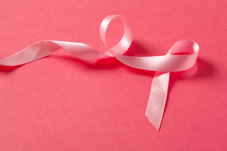 pink ribbon breast cancer on pink backgroundの写真素材