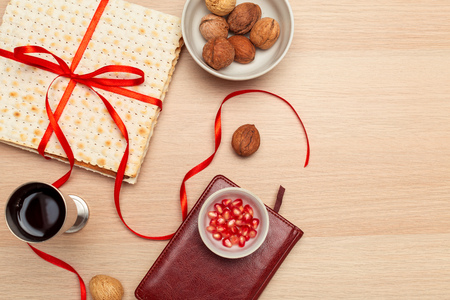 Jewish holiday Passover banner design with wine, matzo  on wooden background. View from above. Flat...