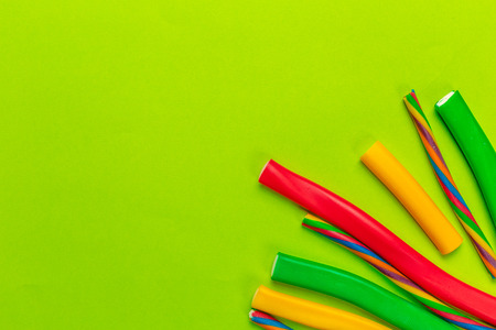 Colorful candies on green background