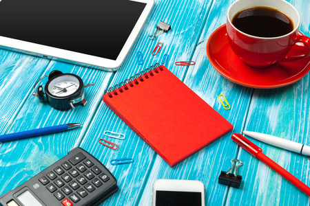 Modern workplace with cup of coffee on wooden tableの写真素材