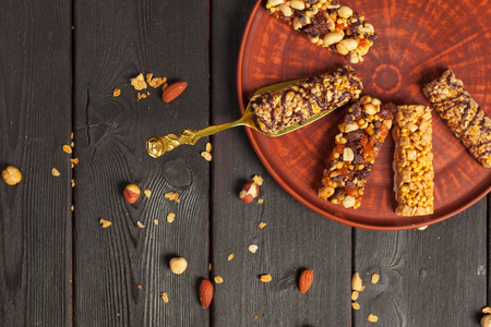Healthy bars with nuts, seeds and dried fruits on the wooden tableの写真素材