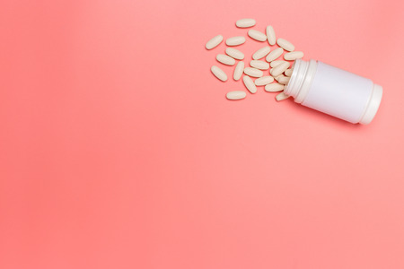 medicine pills on pink background. Top view