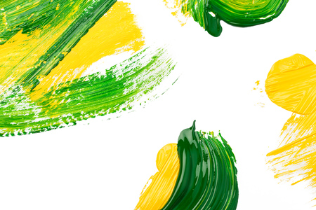 green stroke of the paint brush on white paper