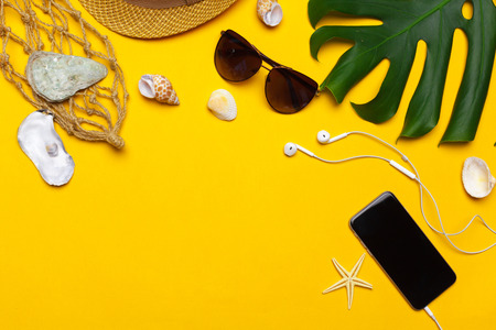 Composition of beachwear and accessories on a yellow background