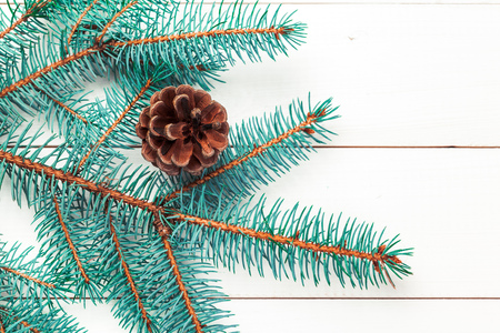 Christmas pine tree branches on wooden board.の写真素材
