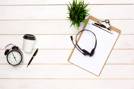 Flat lay of working space supplies on white tableの写真素材