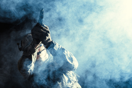 Special forces soldier with rifle on dark backgroundの写真素材