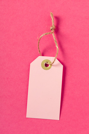 Blank  greeting card or tag  on pink  backgroundの写真素材