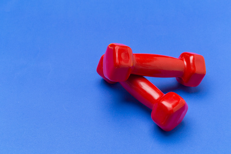 dumbbells on a color backgroundの写真素材