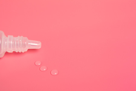 Eye drops isolated on pink background