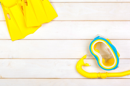 Bright yellow flippers and diving mask on a vibrant backroundの写真素材