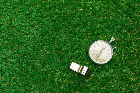 Silver chronometer on green grassの写真素材