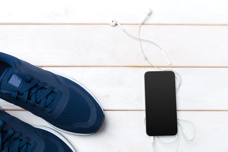 Sneakers and mobile phone with headphonesの写真素材