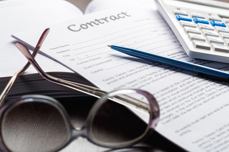 Close up shot of Eyeglasses  on contract document papers business conceptの写真素材