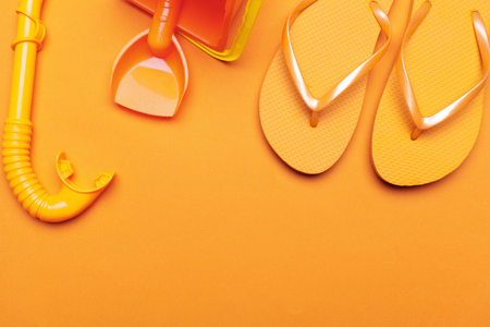 Summer beach flip flops on colored backgroundの写真素材