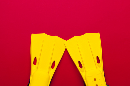 Yellow swimming flippers on colored backgroundの写真素材
