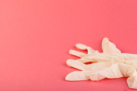 pink rubber gloves  on pink backgroundの写真素材