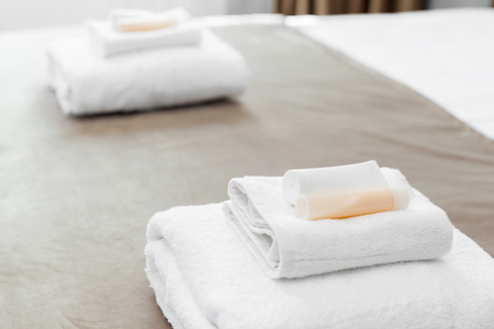 White towel on bed in guest room for hotel customerの写真素材