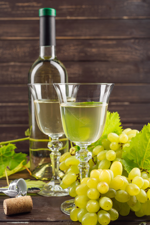 Wine bottle and grape on wooden tableの写真素材