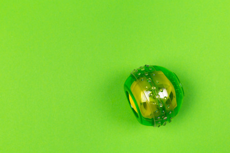 Green wrist ball trainer on green background top viewの写真素材