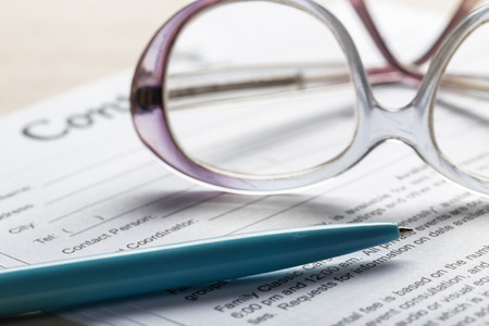 Close up shot of Eyeglasses  on contract document papers business concept
