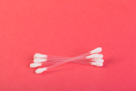 Hygienic cotton buds on pink background close up