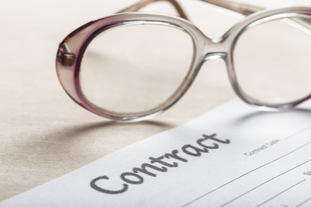 Close up shot of Eyeglasses  on contract document papers business conceptの写真素材