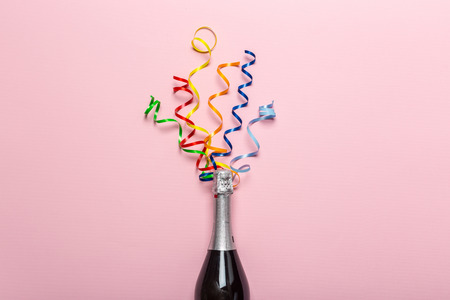 Champagne bottle with colorful party streamersの写真素材