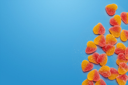 Colorful candies on table on blue background