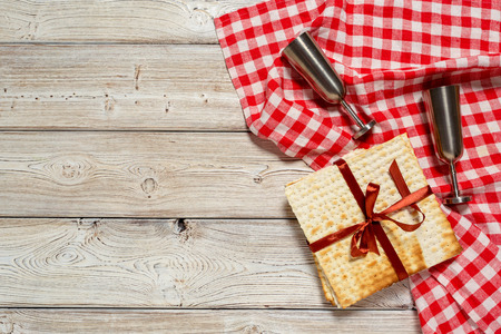 Jewish holiday Passover banner design with wine, matzo on wooden background.