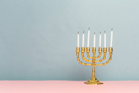 Bronze Hanukkah menorah with burning candlesの写真素材