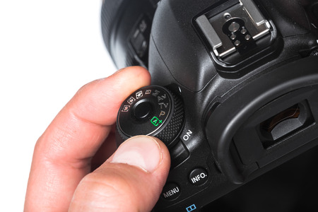 Photo camera in hand isolated on white background
