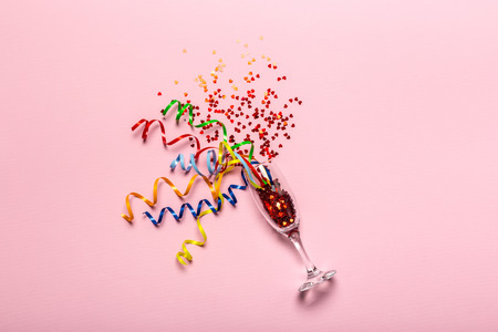 Flat lay of Celebration. Champagne glass with colorful party streamersの写真素材