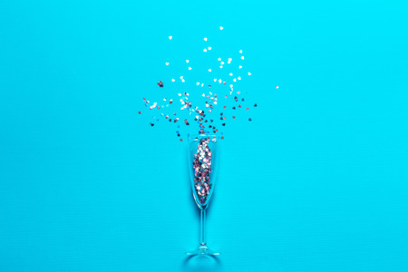 Flat lay of Celebration. Champagne glass with colorful party streamersの写真素材