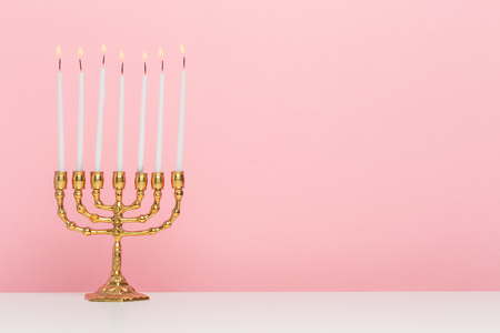 Bronze Hanukkah menorah with burning candlesの写真素材